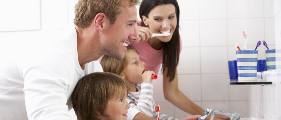 Family brushing their teeth