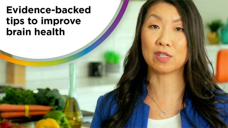 Photo of a dark-haired woman (dietitian Maggie Moon) wearing a white shirt and blue blazer with the text “Evidence-backed tips to improve brain health”