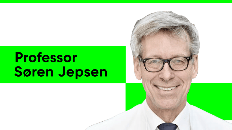 Headshot of Professor Søren Jepsen, a white man smiling broadly with sandy-blonde and grey hair. He wears dark-rimmed glasses, a white shirt and a blue blazer