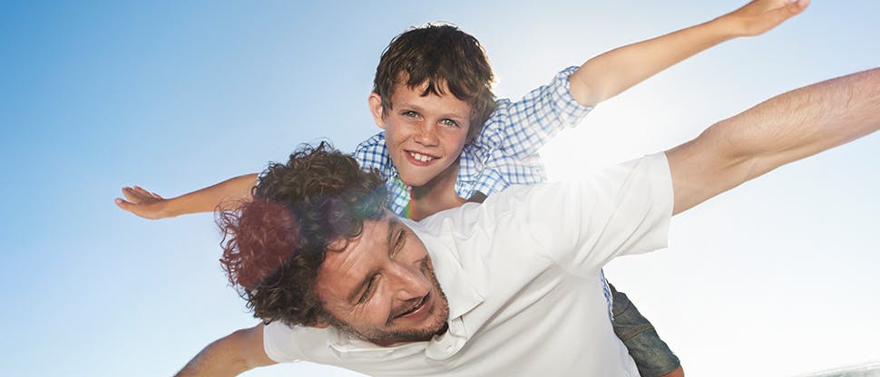 Man playing with son on his back