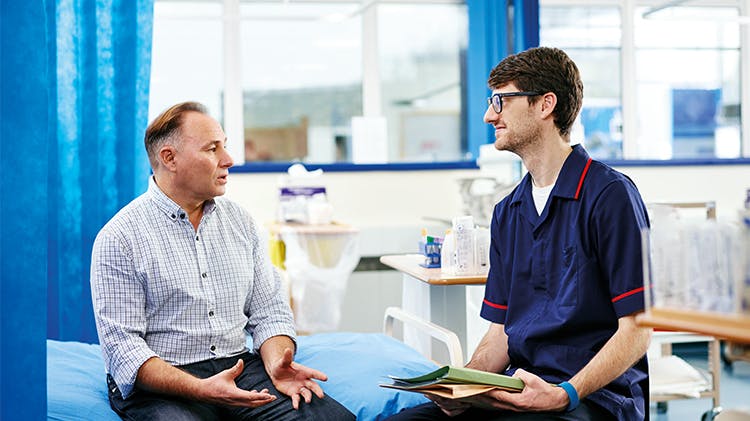 Man discussing with physician 