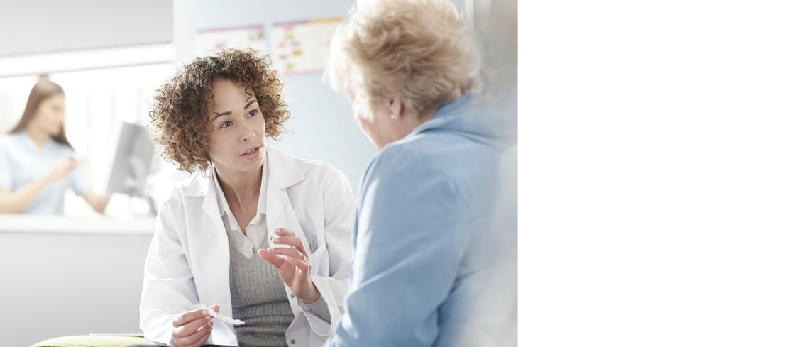 Pharmacists talking to patient