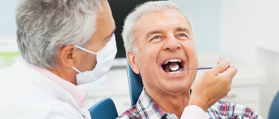 Dentist with senior patient