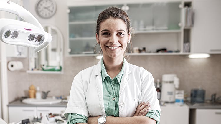 A dentist smiling to camera
