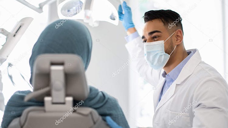 Image of a dentist and patient in conversation