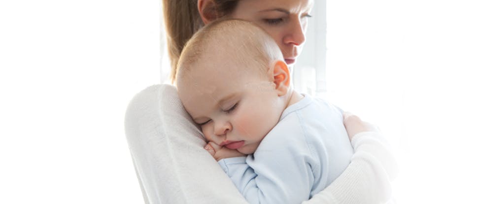 Baby sleeping on mothers shoulder