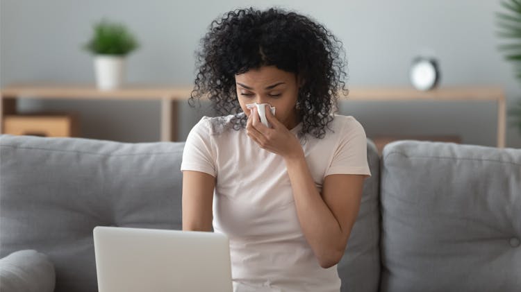 Woman blowing her nose