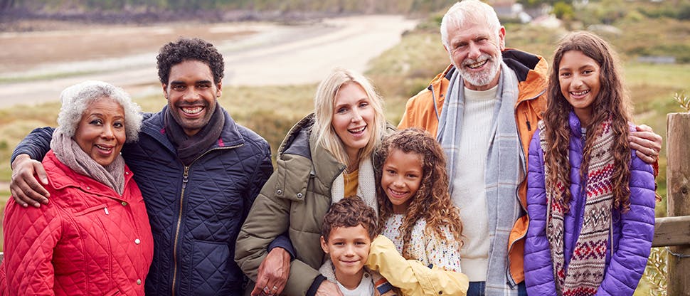 Happy joint family standing in a natural landscape