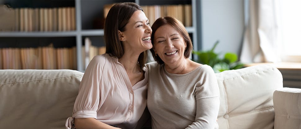 Two women hugging and laughing