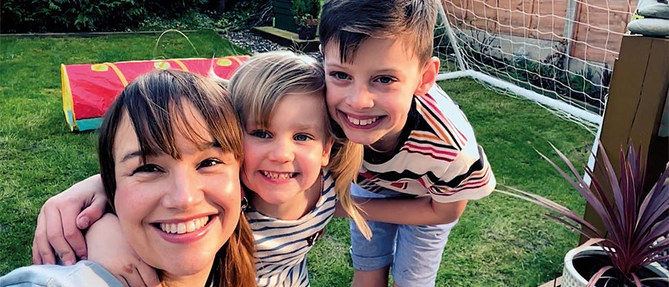 Image of family smiling in the garden