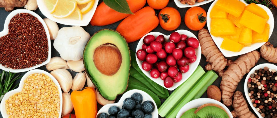 Selection of healthy foods including nuts, grains, vegetables and fruit