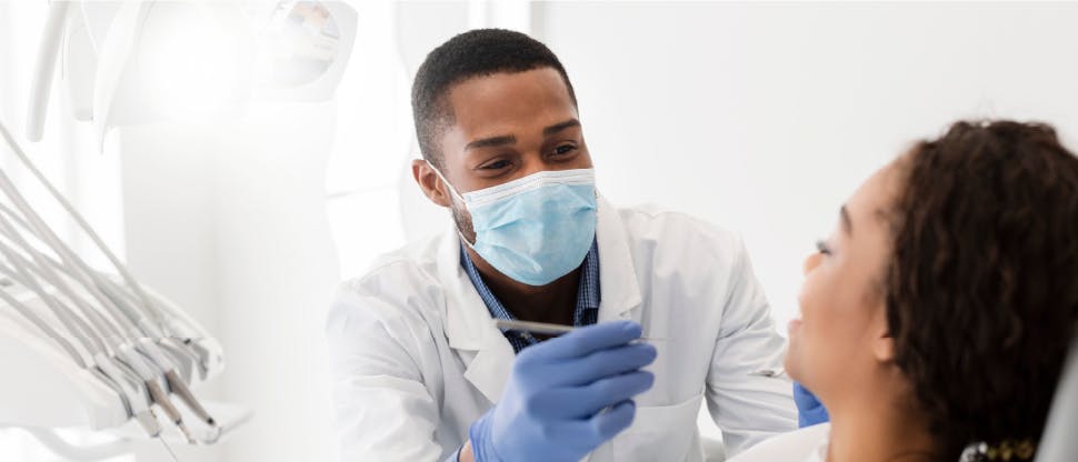 Dentist checking patient for signs of enamel erosion