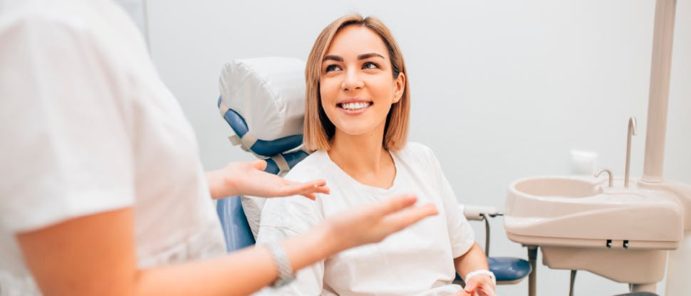 Dentist with smiling patient in dentist’s chair