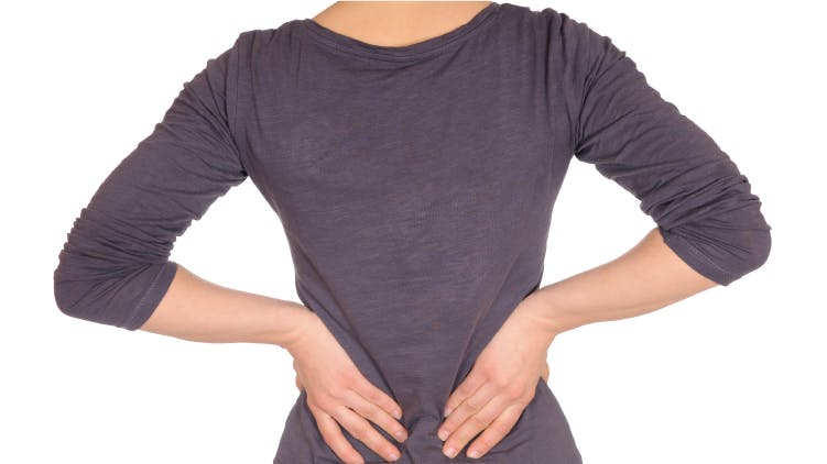 Woman holding her lower back