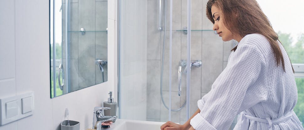 Worried woman at sink