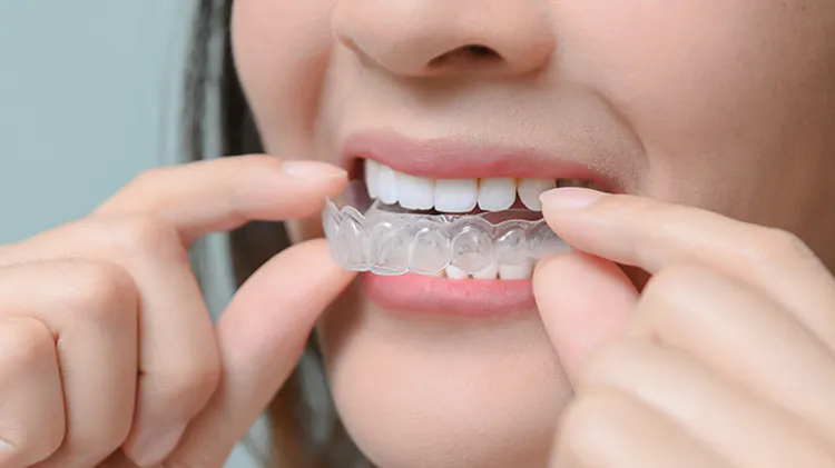 Woman holding removable retainer