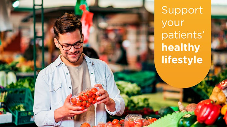 Image of man with tomatoes in a market