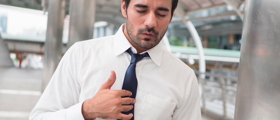 Man suffering with heartburn symptoms