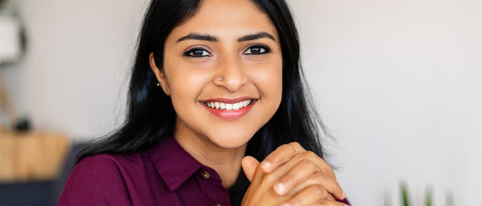 Image of a woman in her twenties smiling.