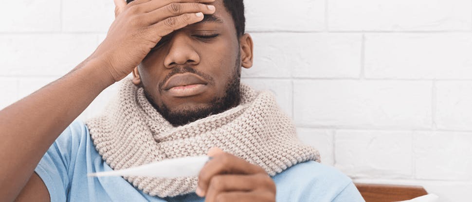 The image is of a man holding his head