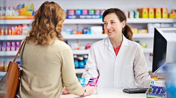 Image of pharmacist and female patient in store