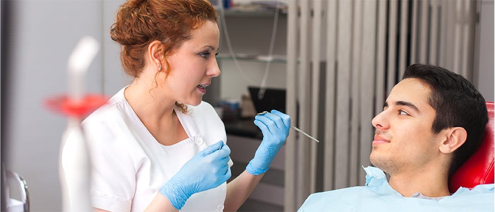 Dentist speaking with patient