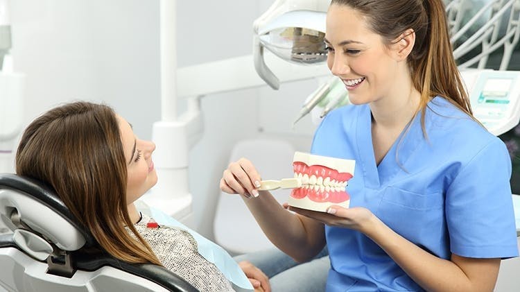 A dentist shakes hand with patient