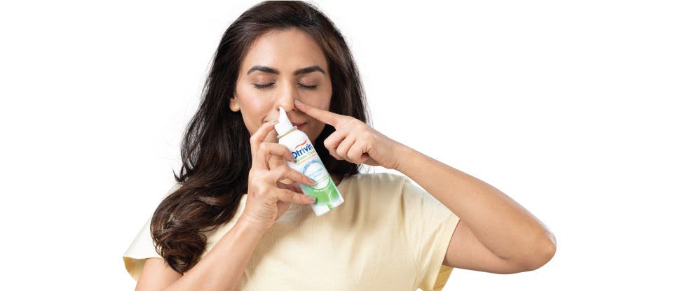 Woman with nasal spray