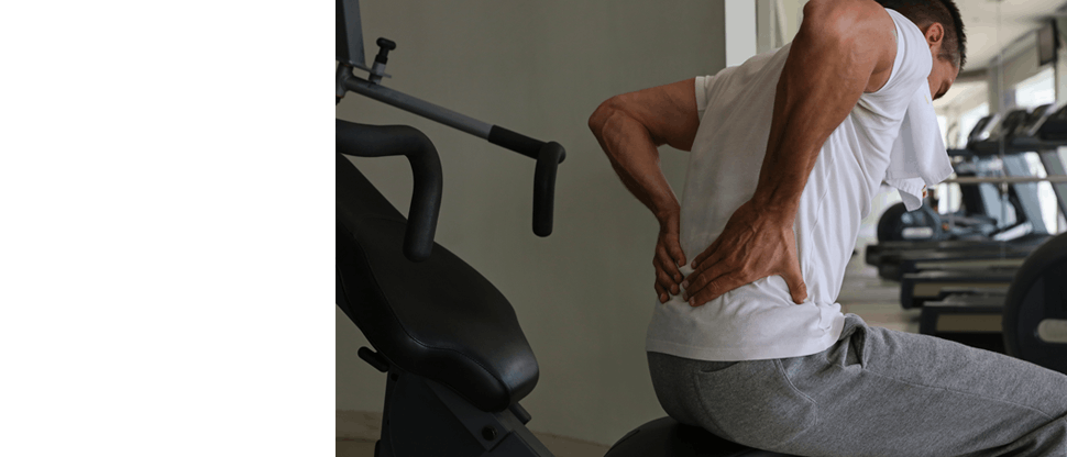 Man holdering his lower back with both hands