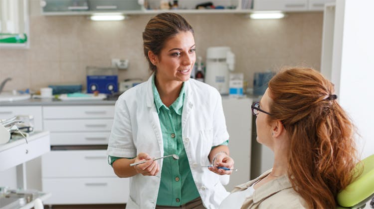Dentist talking to a patient