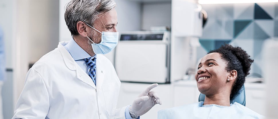 Dentist and smiling dental patient.