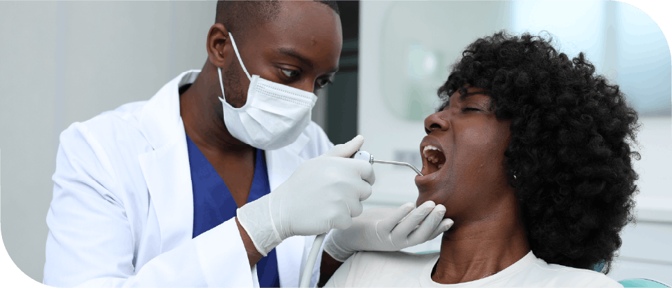 African dentist with female patient