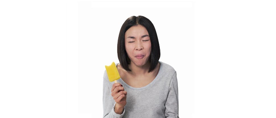 Woman experiencing painful ice lolly bite