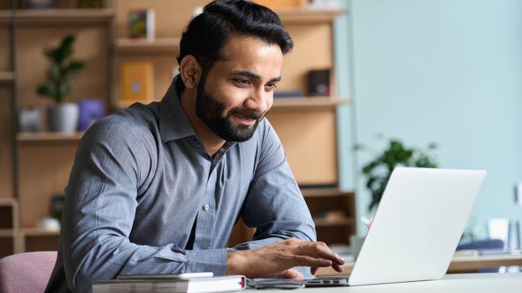 Man smiling at desk