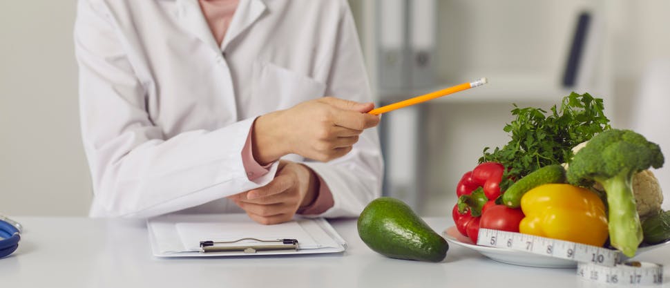 Nutritionist pointing to vegetables