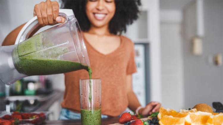 Woman pouring smoothie