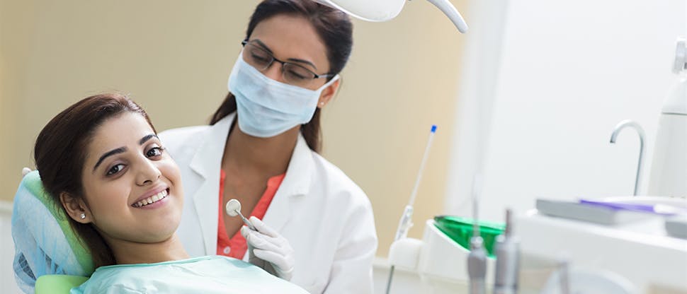 Dentist speaking with patient