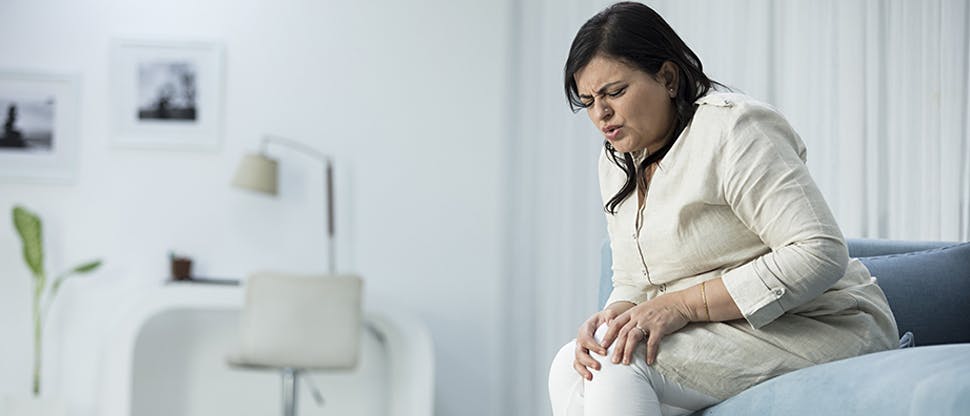 Woman holding knee