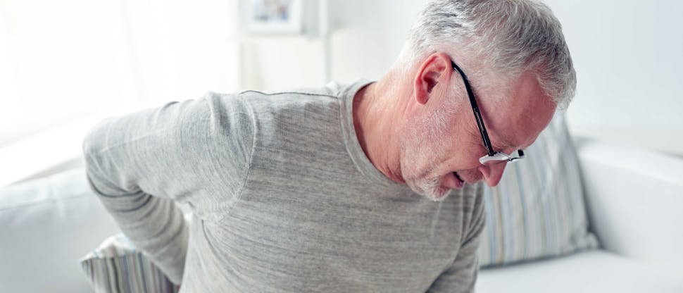 A middle-aged man suffering from low back pain