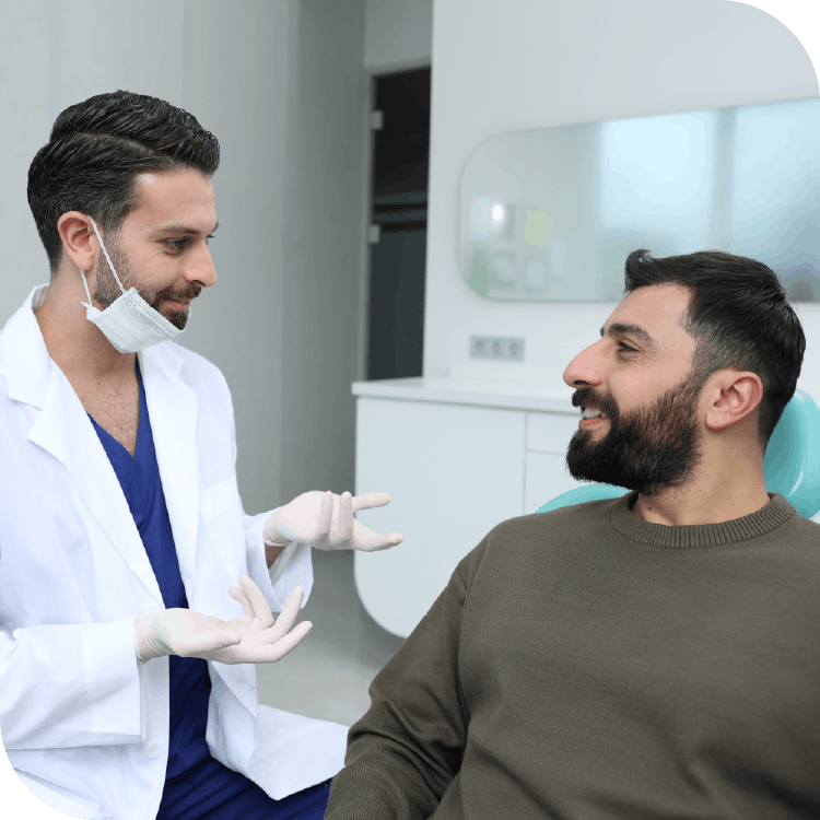 Pakistan dentist talking to male patient