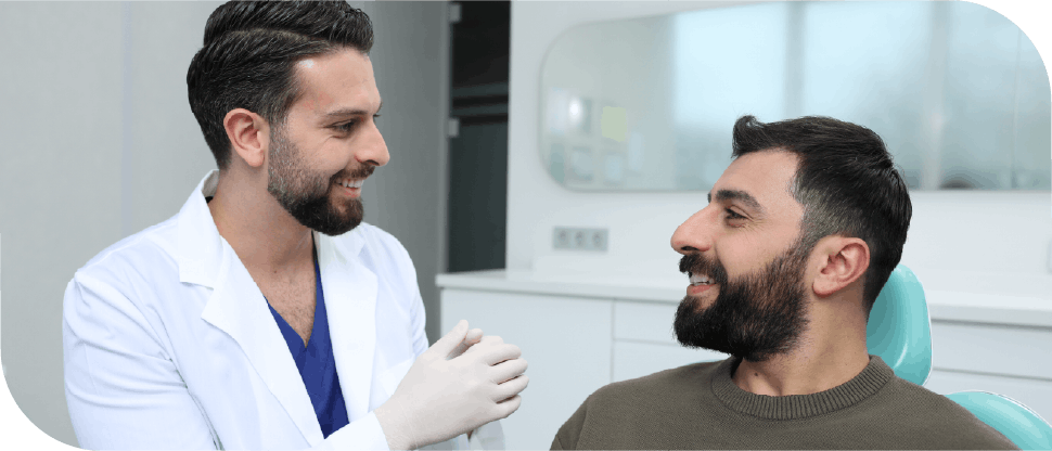 Male Pakistan dentist caring for male patient