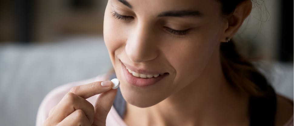 Woman taking a multivitamin