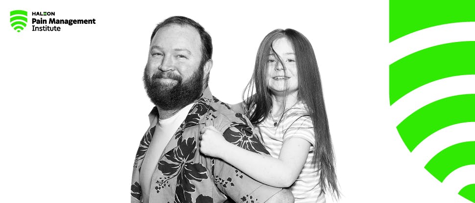 Man carrying a child and HPMI logo in the background