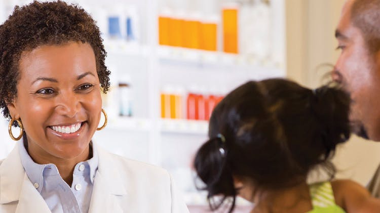 A pharmacist seeing a young child and her parent