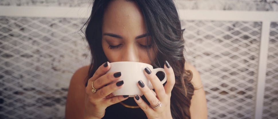 Woman drinking hot liquid