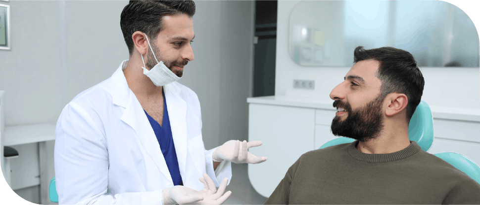 Male arab dentist caring for male patient