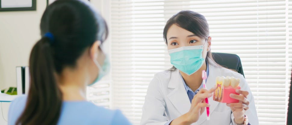 Dentist speaking with patient