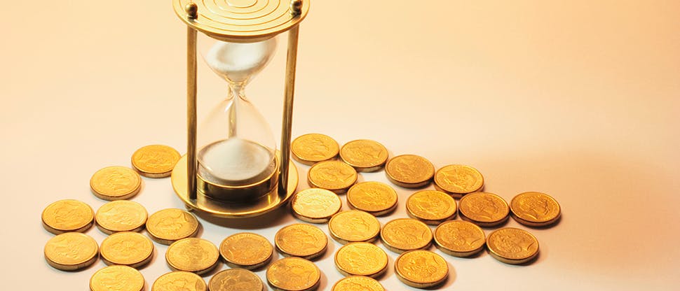 Hourglass surrounded by gold coins