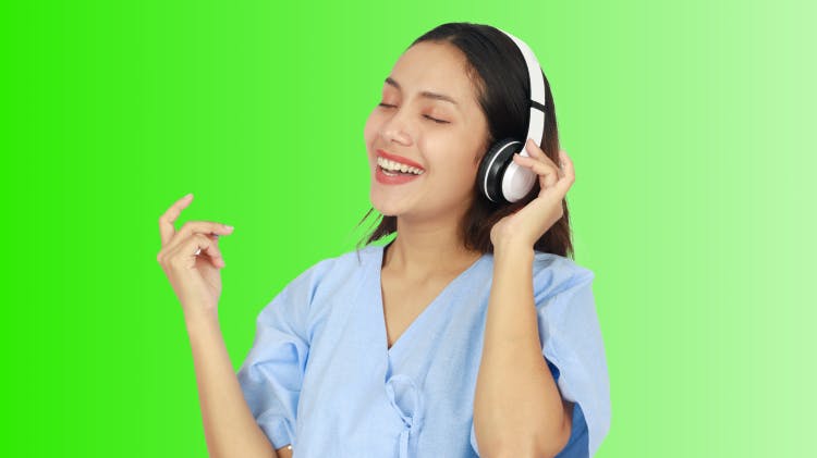 Image of dental hygienist with headphones on, listening to an energetic music playlist