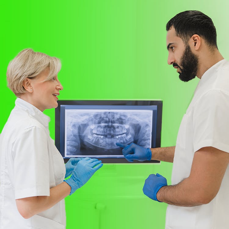 Hygienists looking at computer